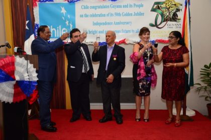 Prime Minister Moses Nagamootoo performing the duties of President, toasts with Chilean Ambassador to Guyana Claudio Rachel Rojas, Honorary Consul to Chile, Yesu Persaud along with the spouse of the Prime Minister, and the Ambassador 