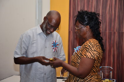 Genevieve Whyte-Need receiving her token of appreciation from Advisor to the Minister of Education, Vincent Alexander.