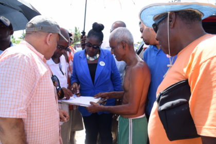 Minister within the Ministry of Communities Valerie Adams Patterson listens to a resident’s concern in Tuschen