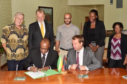 Minister of State, Mr. Joseph Harmon and Germany’s Regional Director for Latin America and the Caribbean, Ambassador Dieter Lamle signing the agreement at the Ministry of the Presidency. Looking on are, from left: Mr. Ben Ter Welle, Ambassador Lutz Hermann Gorgens, Commissioner of the Protected Areas Commission (PAC), Mr. Damian Fernandes, Ms. Ndibi Schwiers-Ceres and Deputy Commissioner at the PAC, Ms. Denise Fraser 