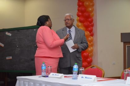 Minister of Agriculture, Noel Holder and Registrar of the PTCCB, Tricia Garnath in discussion at the PTCCB drama competition finals at the Ramada Princess