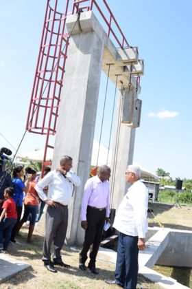 Minister of Agriculture Noel Holder and other officials taking a look at the newly commissioned sluice