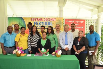 Director General of Tourism, Donald Sinclair (left) and Director of the Guyana Tourism Authority Harold Singh with the sponsors of the coconut festival