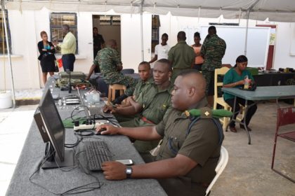Members of the Guyana Defense Force are geared up as they await patrons to visit their booth