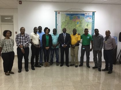 Suriname’s Minister of Natural Resources Mr. Regilio J. Dodson flanked by GWI and SWC officials.  