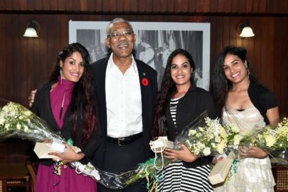 President David Granger is flanked by the birthday girls; from left to right: Ms. Radha Mansaram, Ms. Rajshri Mansaram and Ms. Reenica Mansaram.