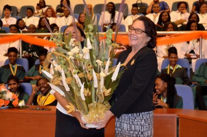 A huge thank you! First Lady, Mrs. Sandra Granger and Head Prefect of the 2017 graduating class of the Carnegie School of Home Economics, Ms. Sheina Ramsden share a laugh as they display a stunning bouquet the school presented to the First Lady in appreciation of her attendance. 