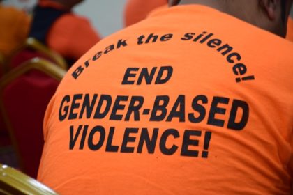 Persons outfitted in bright orange t-shirts spreading the message, ‘Break the silence!’