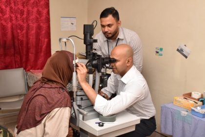 Head of GPHC’s Ophthalmology Department, Dr. Shailendra Sugrim assisting Dr. Ronnie Bhola with a patient