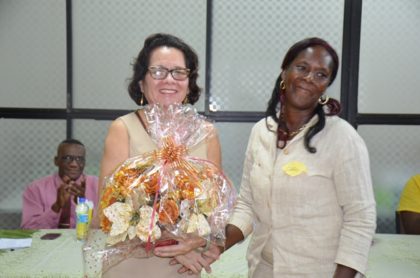  First Lady Mrs. Sandra Granger smiles after receiving a bouquet from graduate Ms. Cathy McNabb at the graduation ceremony.    
