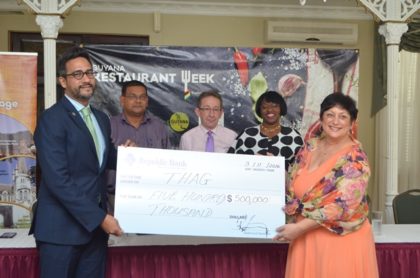 Richard Sammy, Managing Director of Republic Bank (Guyana) Limited, hands over the cheque to Andrea de Caires, President of the Tourism &Hospitality Association of Guyana (THAG). In the background from left-Mr. Indranauth Haralsingh Director of the Guyana Tourism Authority, Shaun McGrath, Executive Member of THAG and Michelle Johnson, Marketing and Communications Officer, Republic Bank.