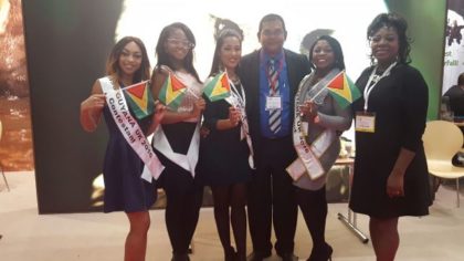 Miss UK Guyana contestants pose for a picture with Director of the Guyana Tourism Authority, Indranauth Haralsingh, in the Guyana booth at the World Travel Market, London  